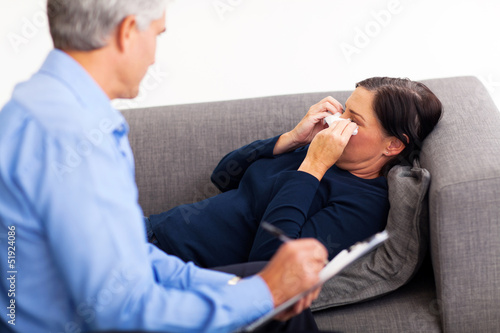 Photo: middle aged patient crying in therapist office middle aged patient crying in therapist office