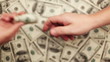 Give bribe, Lots of hundred dollar bills
