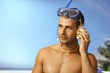 Photo: Young scuba diver listening to seashell Young scuba diver listening to seashell