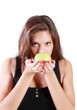 Beautiful brunette girl sniffs green apple isolated on white