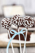 Chocolate cake pops decorated with white icing.