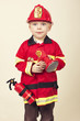 Cute Young Boy in a Fireman s Costume