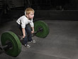 Determined Young Boy trying to lift Heavy weights
