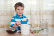 boy puts plant in pot