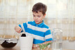 boy puts plant in pot