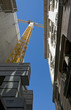 Narrow alley surrounded by old palaces with building site crane