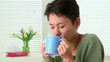 Woman sick with flu sneezing and drinking tea