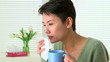 Woman sick with flu sneezing and drinking tea