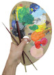 hand holding palette and brush
