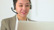 Asian customer service representative with headset in call cente