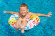 little girl in the pool  with rubber ring