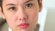 Serious Asian business woman working at laptop