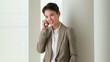 Happy Asian business woman talking on mobile phone