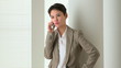 Happy Asian business woman talking on mobile phone