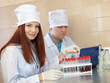 scientific workers with test tubes