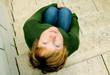 beautiful red-haired girl sitting alone on staircase