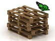 Green butterfly is sitting on a stack of wooden pallets