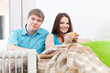 Couple near oil heater