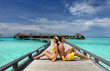 Couple on a beach jetty at Maldives