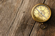 Antique compass over wooden background