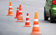 Photo: Striped orange cones and car on the asphalt road Striped orange cones and car on the asphalt road