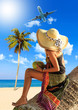 Foto: Woman in sarong on a coconut tree Woman in sarong on a coconut tree