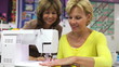 Video: Teacher Showing Woman How To Sew Using Electric Machine Teacher Showing Woman How To Sew Using Electric Machine