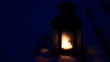 Candle lamp on snowy bench