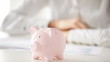 female hand inserting euro money into piggy bank