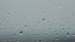 grey rainy glass with water drops