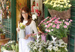 Smiling Mature Woman Florist  At Flower Shop