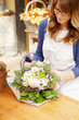 Smiling Mature Woman Florist  At Flower Shop