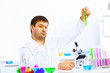 Photo: Young male scientist working in laboratory Young male scientist working in laboratory
