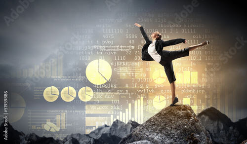 Photo: businesswoman standing atop of mountain businesswoman standing atop of mountain