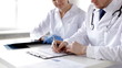 two doctors with x-ray prints and papers