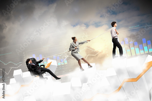 Photo: Three business people pulling rope Three business people pulling rope