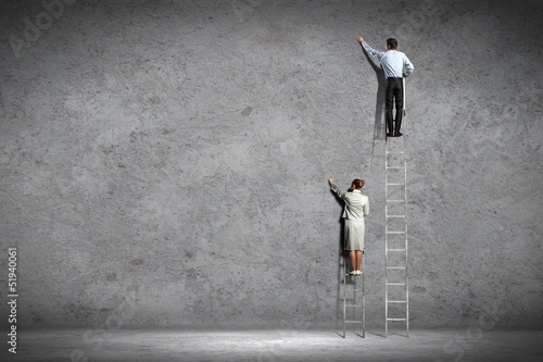 Photo: businesspeople drawing diagrams on wall businesspeople drawing diagrams on wall