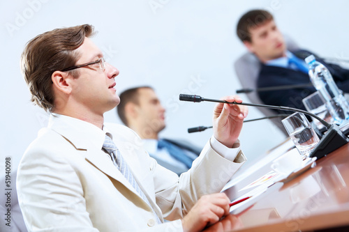 Photo: Three businesspeople at meeting Three businesspeople at meeting