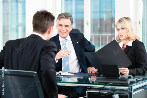 Photo: Business - young man sitting in job Interview Business - young man sitting in job Interview