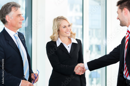 Photo: Business people doing Handshake Business people doing Handshake