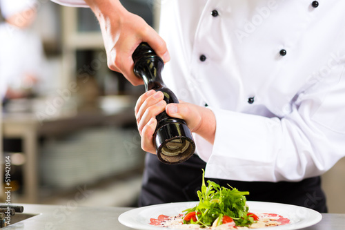 Photo: Chef in hotel or restaurant kitchen cooking Chef in hotel or restaurant kitchen cooking