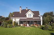 Foto: A new house with a garden in a rural area under beautiful sky A new house with a garden in a rural area under beautiful sky