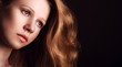 Foto: sad, melancholy girl with long red hair on a dark background sad, melancholy girl with long red hair on a dark background
