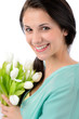 Foto: Cheerful young woman with bouquet of tulips Cheerful young woman with bouquet of tulips