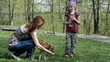 Mom and daughter give to drink with water  dog