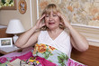 Old woman suffering with fever in the bedroom