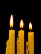 yellow candles isolated on black background