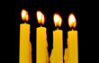 yellow candles isolated on black background