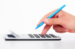 Foto: Hand with a calculator. Hand with a calculator.