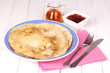 Stack of tasty pancakes on wooden background